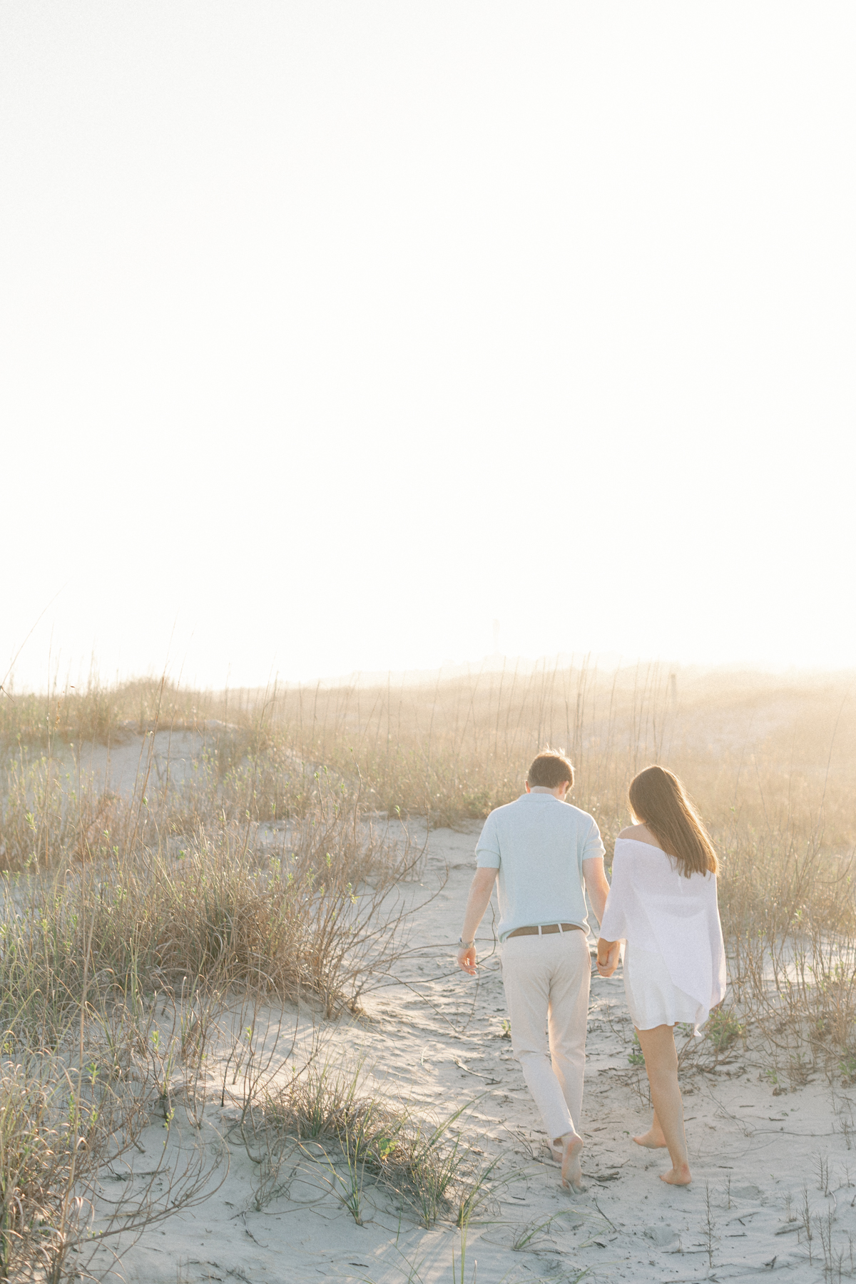 Couple walking away on beach