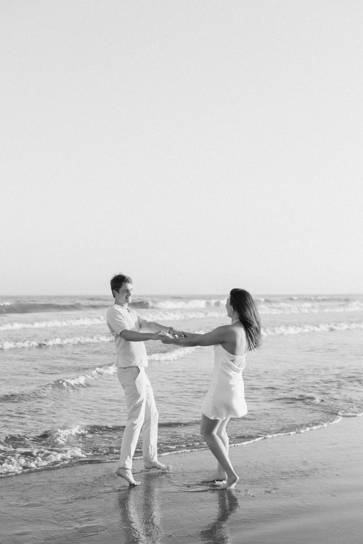 Couple twirling by the water