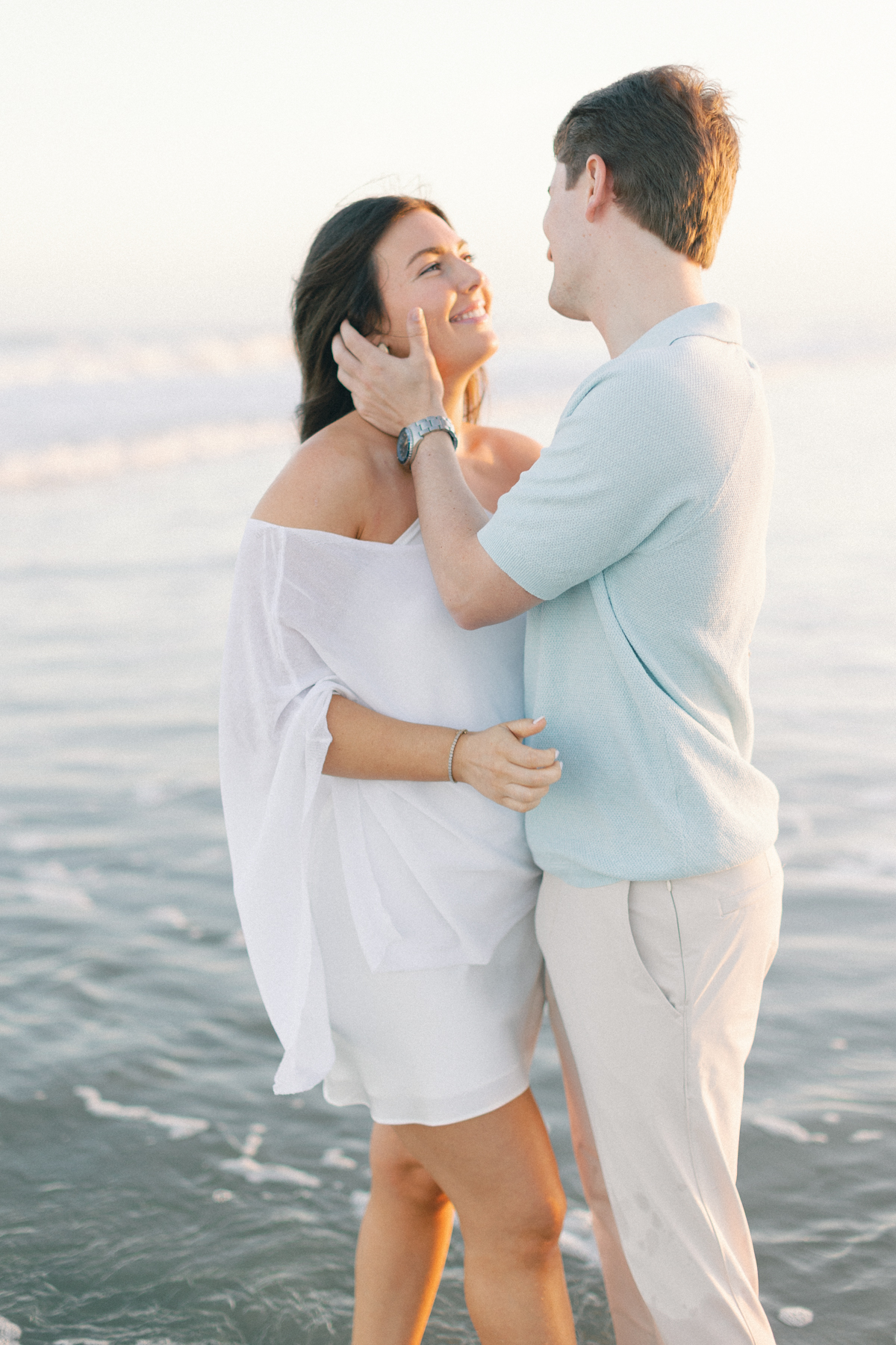 Couple cuddling by water