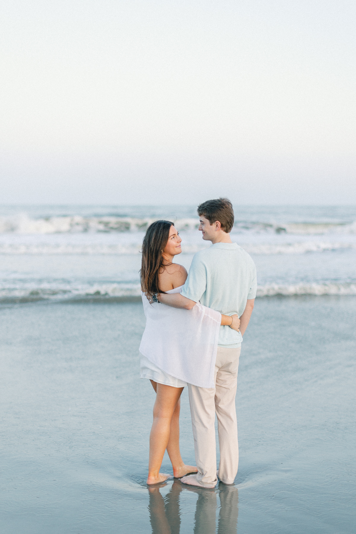 Couple cuddling by water
