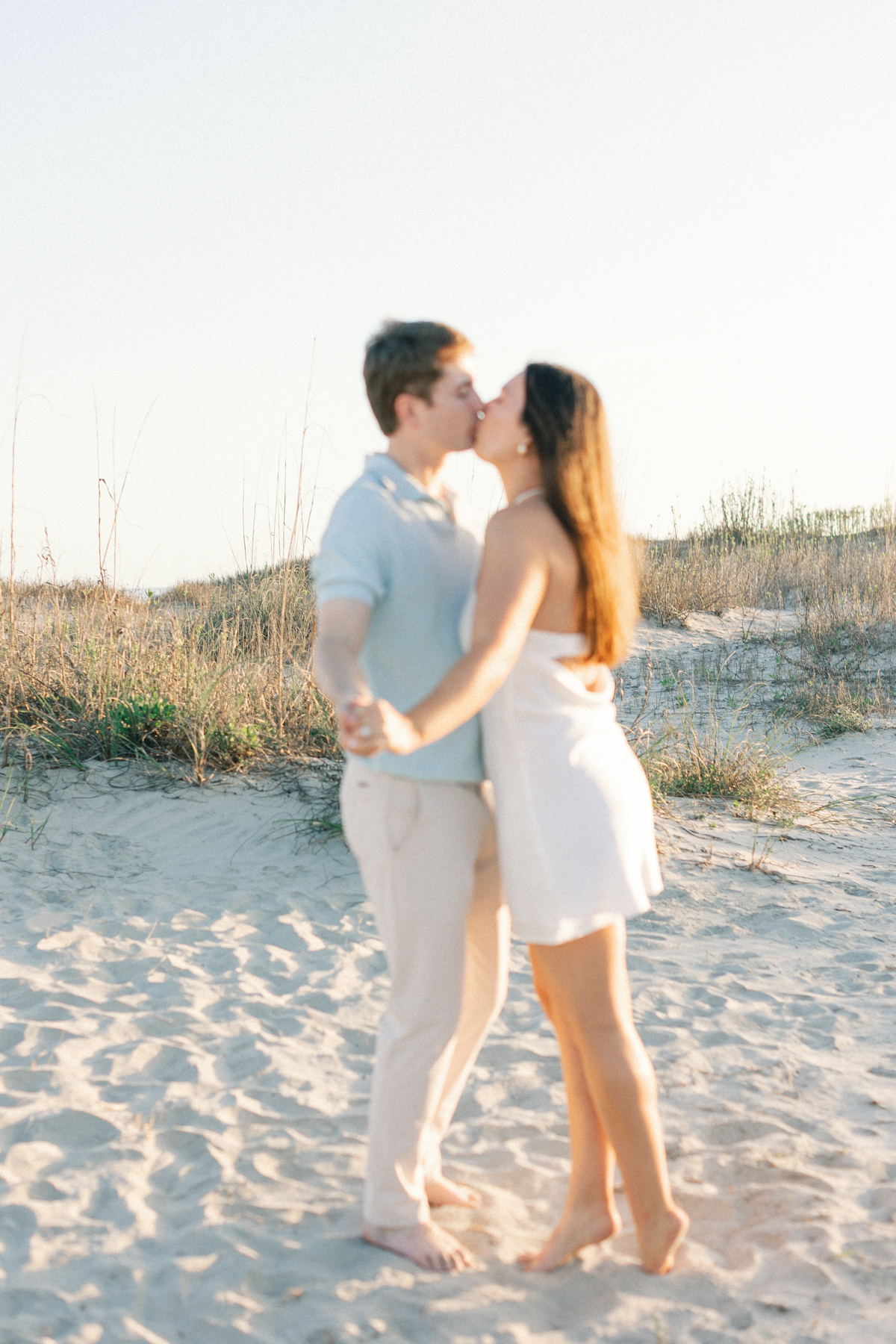 Couple out of focus in the sand