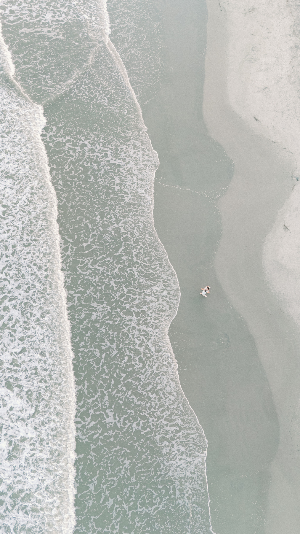 drone shot of couple walking