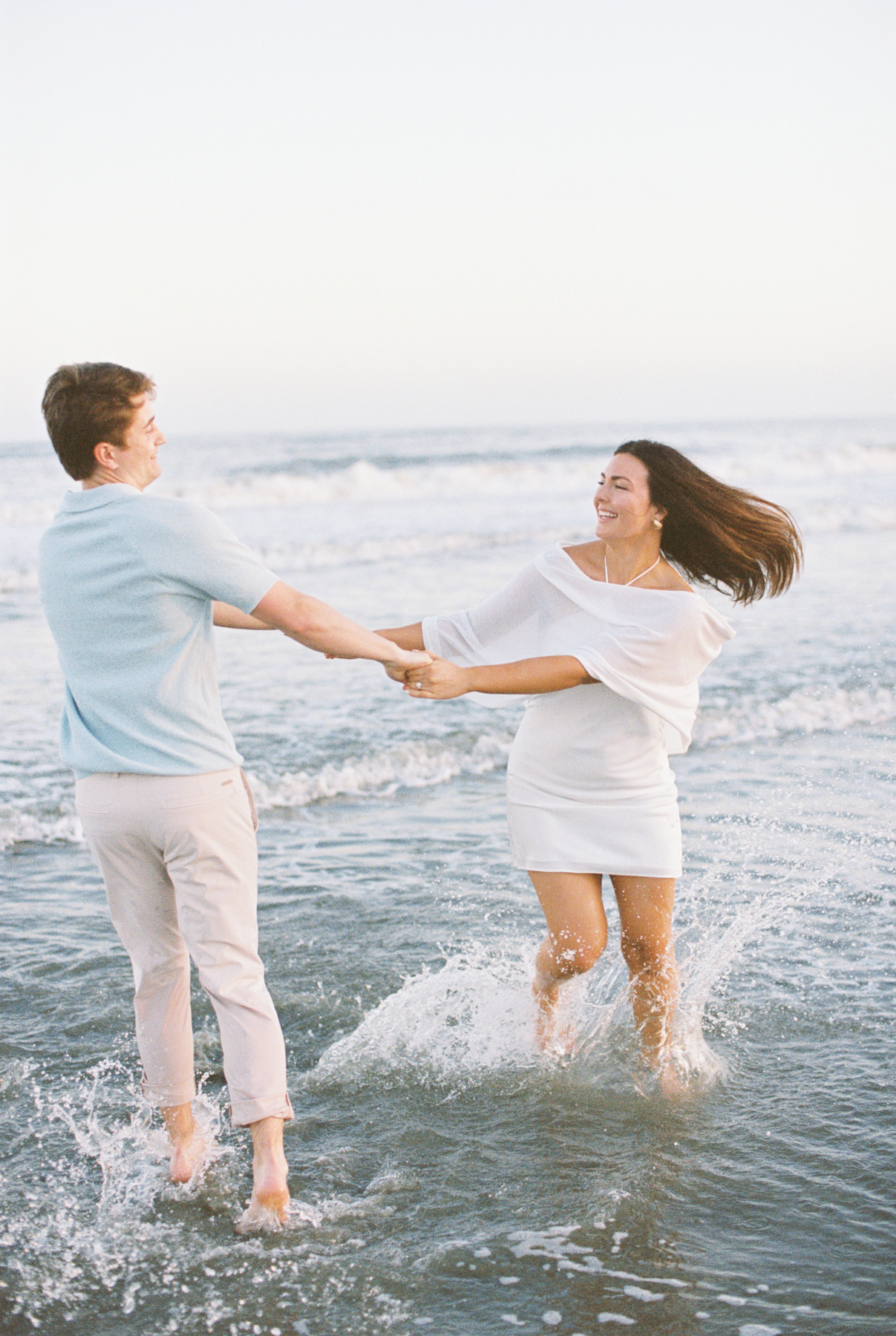 Couple twirling in water