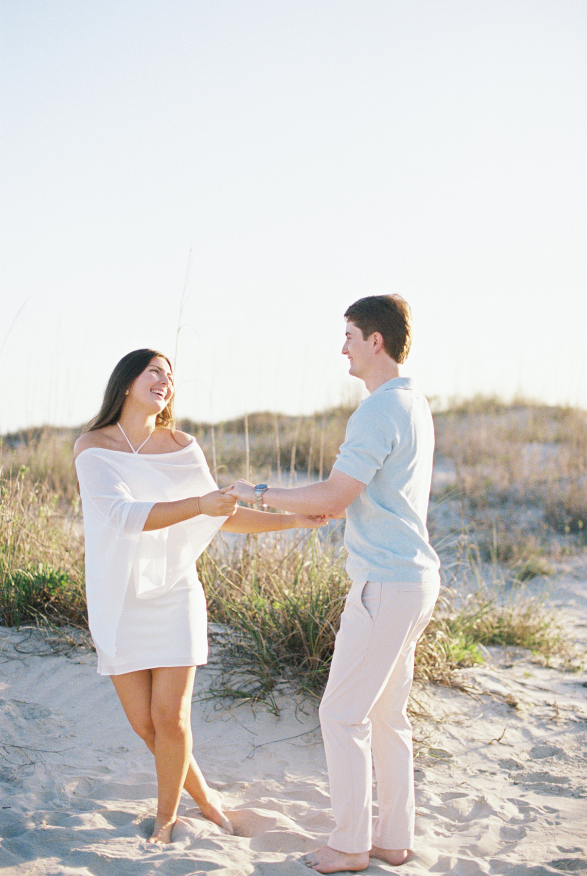Couple twirling in sand
