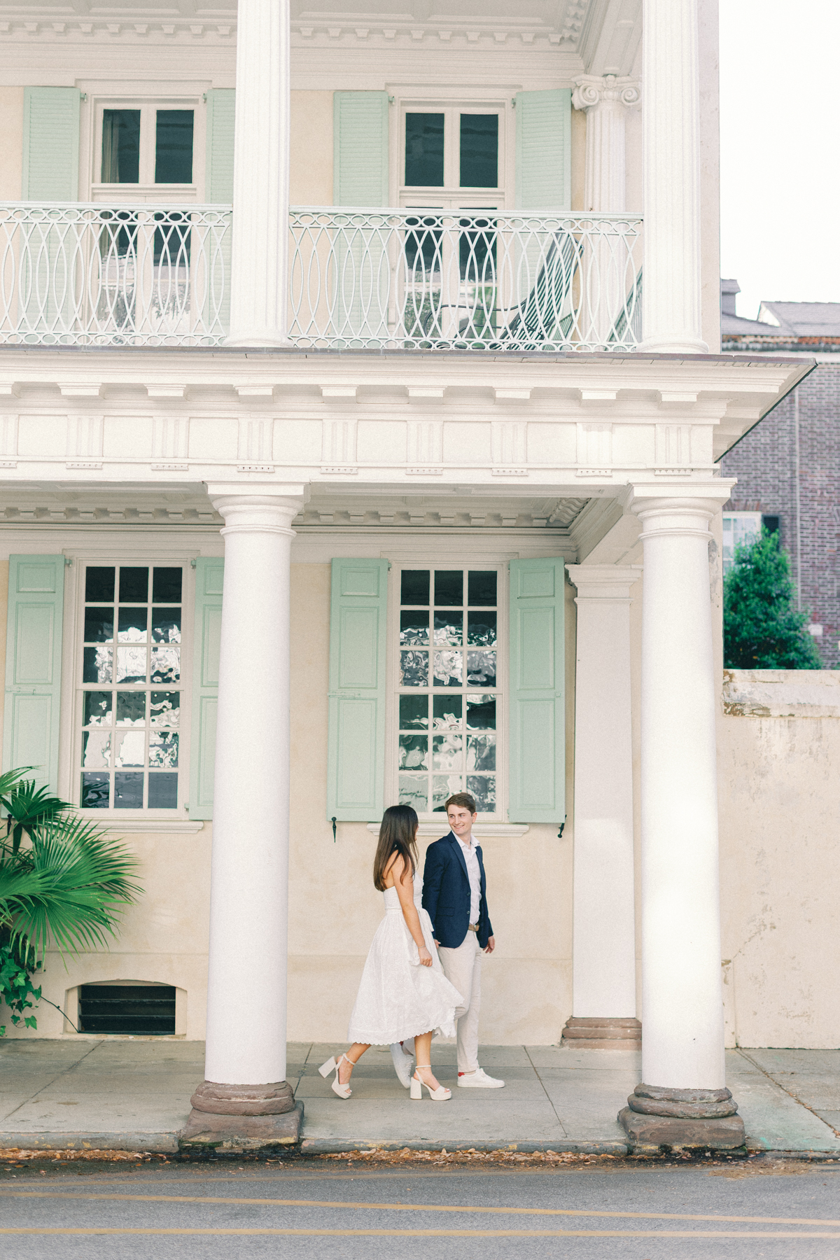 Couple walking under a cute building