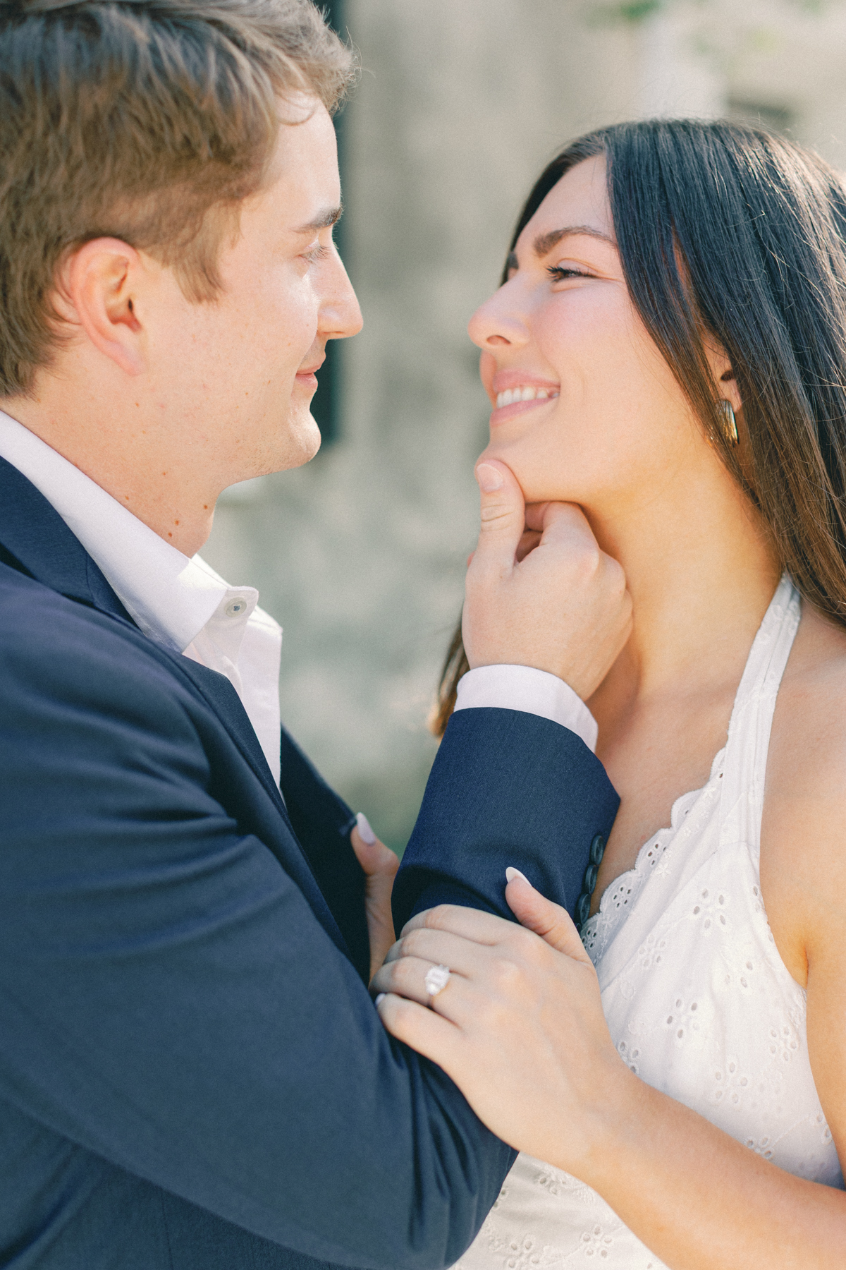 (groom) holding her chin