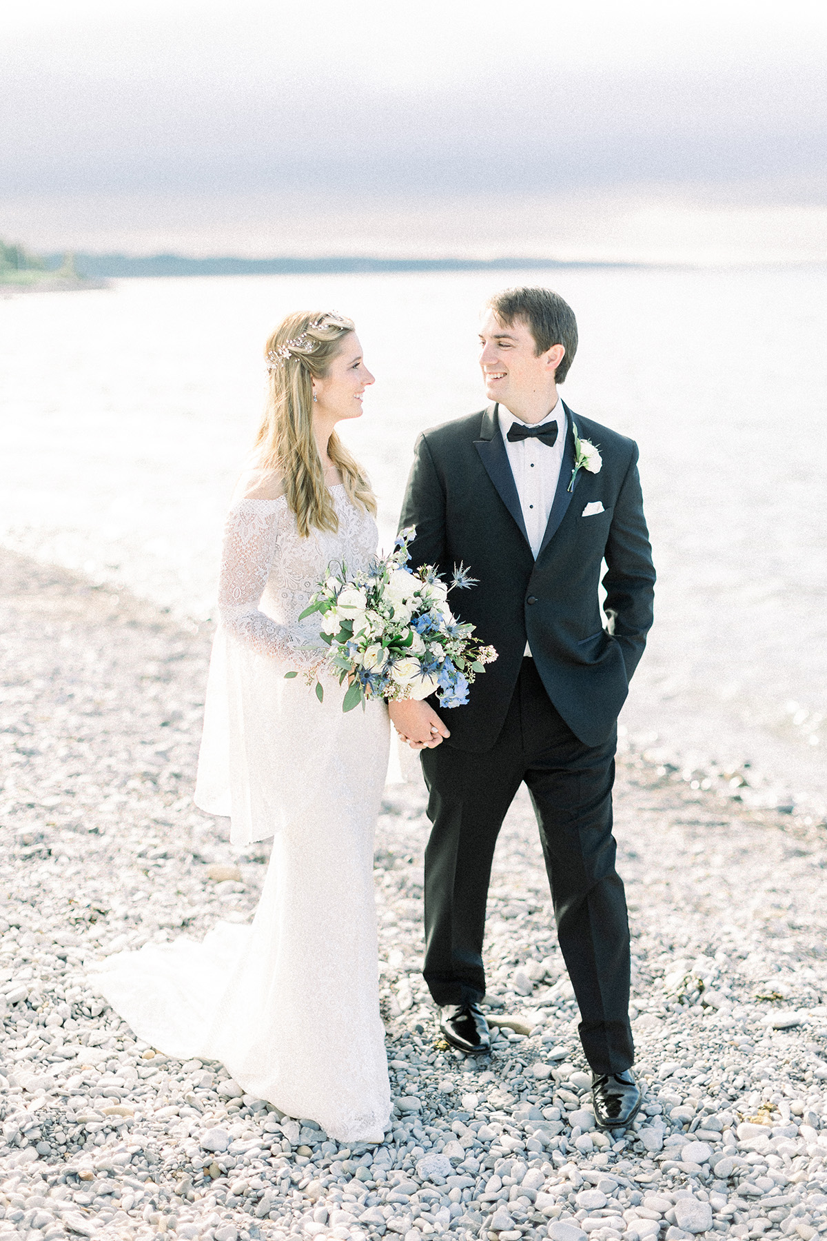 Couple by shoreline at Inn at Bay Harbor, a Petoskey wedding venue
