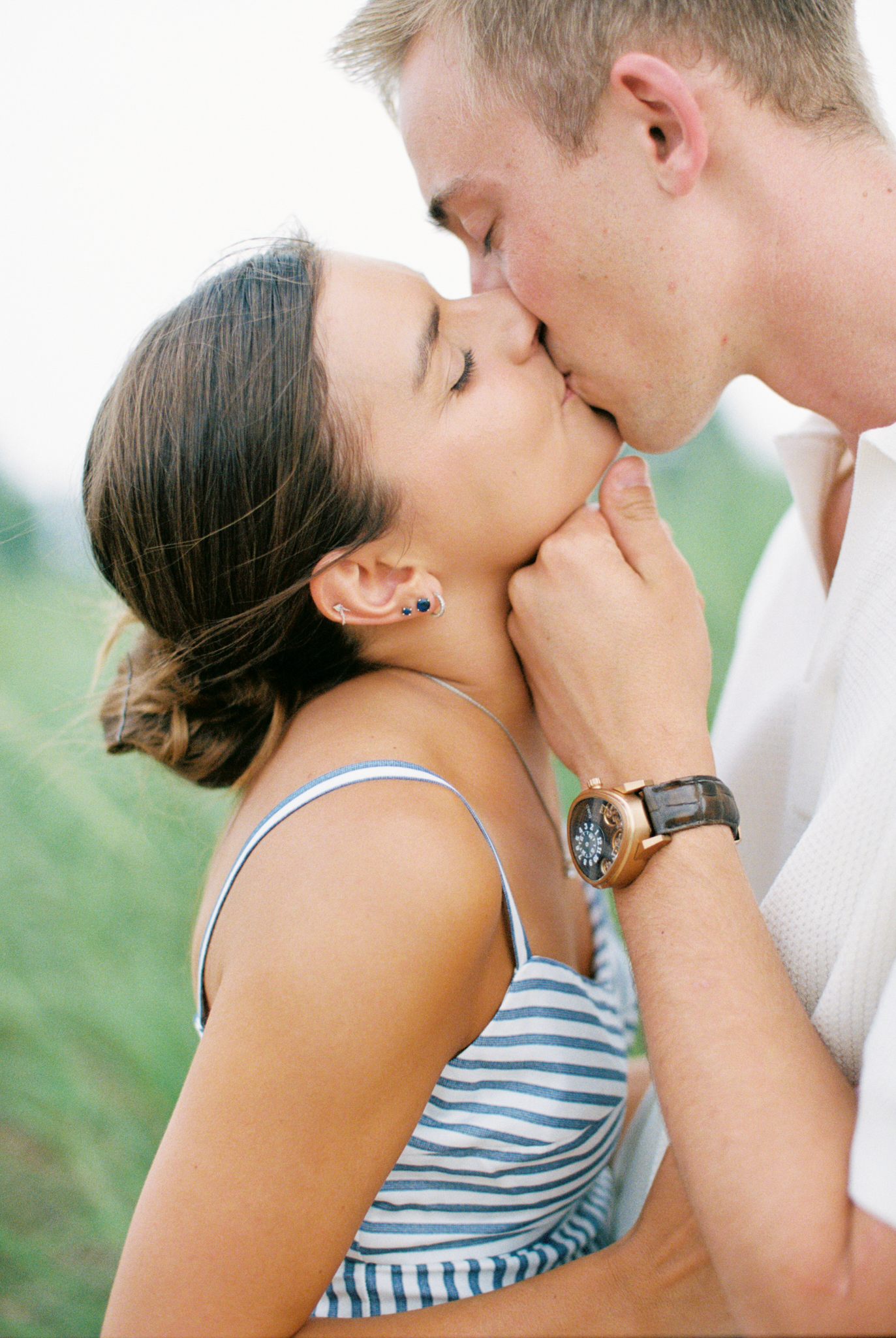 Close-up of Emma and Caleb kissing on the beach during their Port Huron, Michigan engagement session.