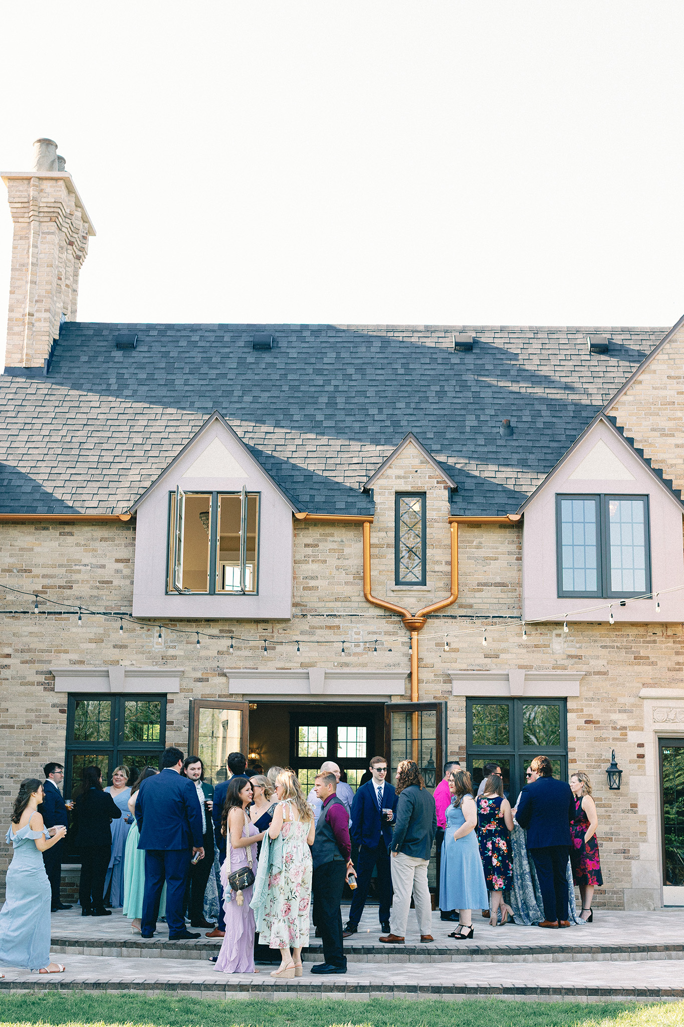 wedding guests at outdoor cocktail hour at michigan estate wedding venue — hayley moore photography